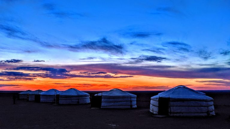Yurts Underneath a colourful sunset