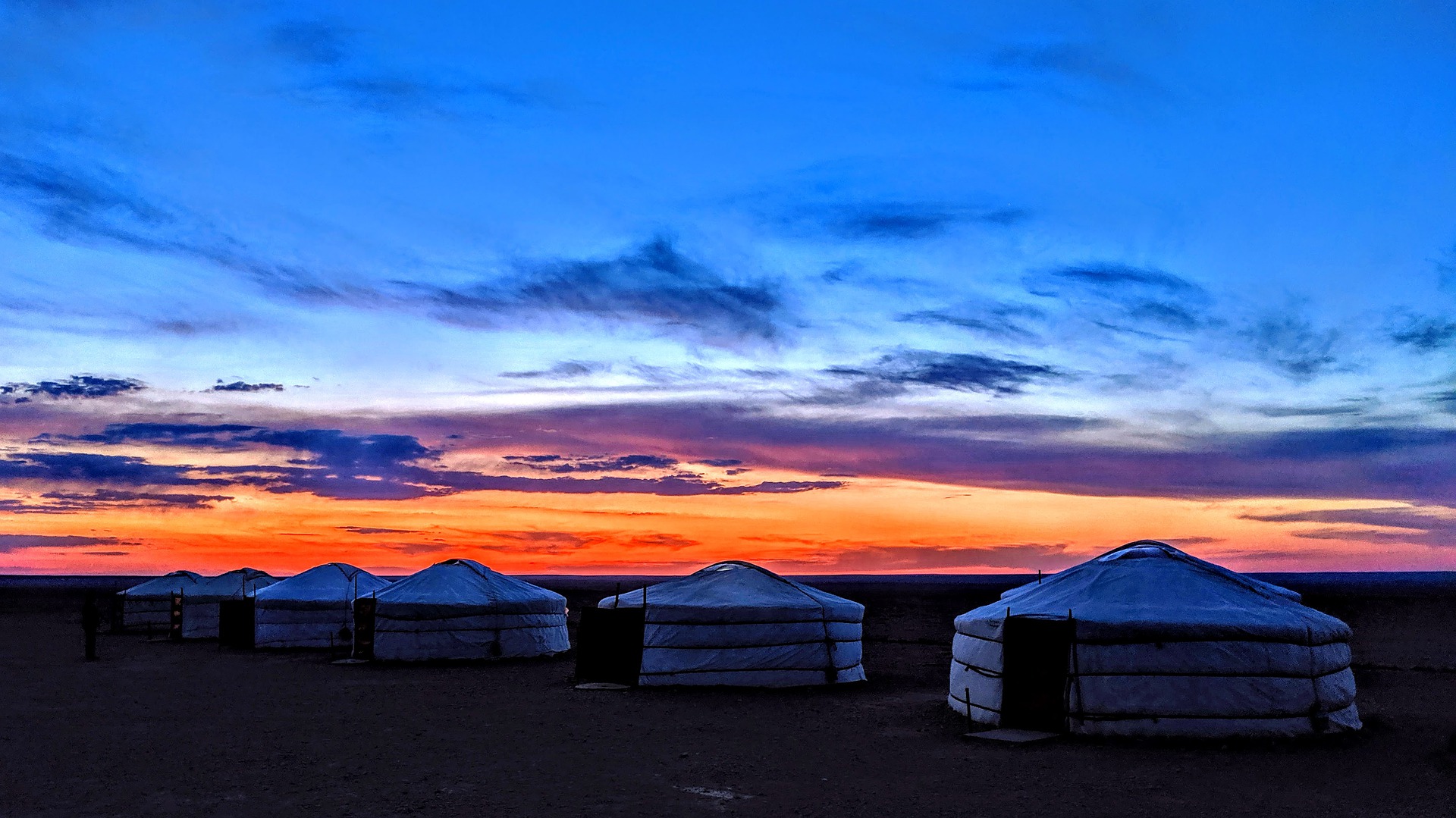 Yurts Underneath a colourful sunset
